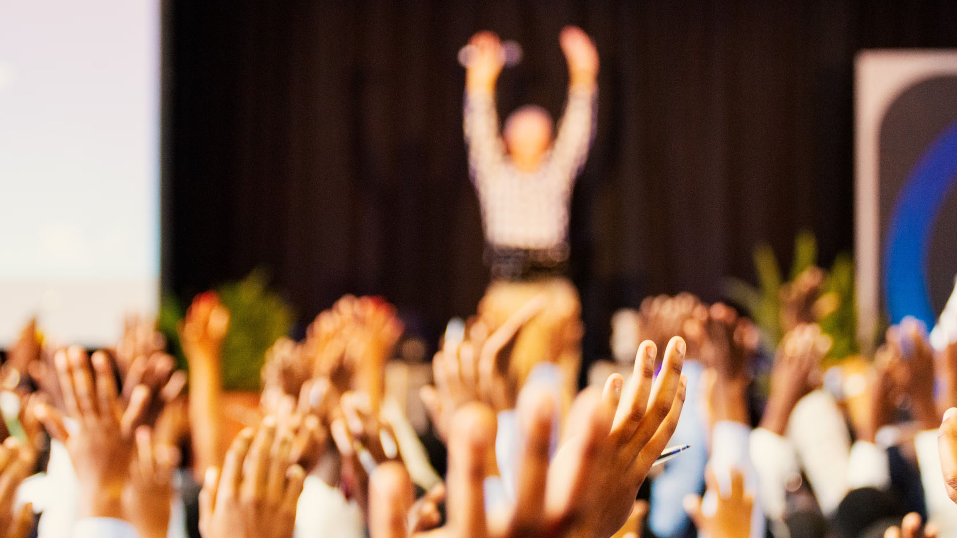 Attendees at a conference raising hands